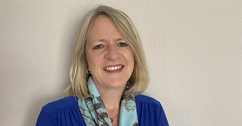 Professor Judith Ranking smiling wearing a blue top and turquoise flowery scarf